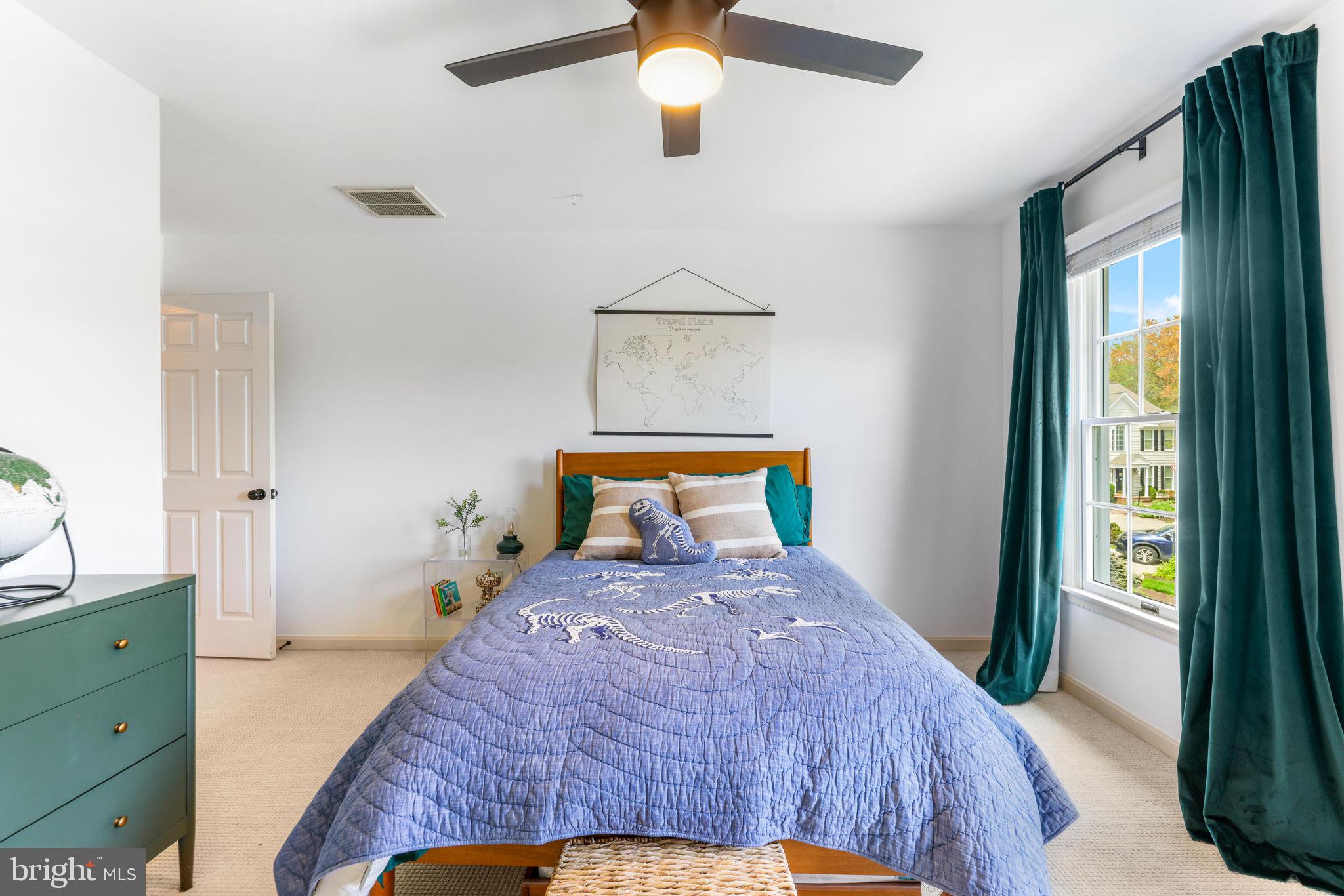 6513 Apple Blossom Ride Columbia, MD 21044 - Photo 56 of 115 a bedroom with a bed and a chandelier