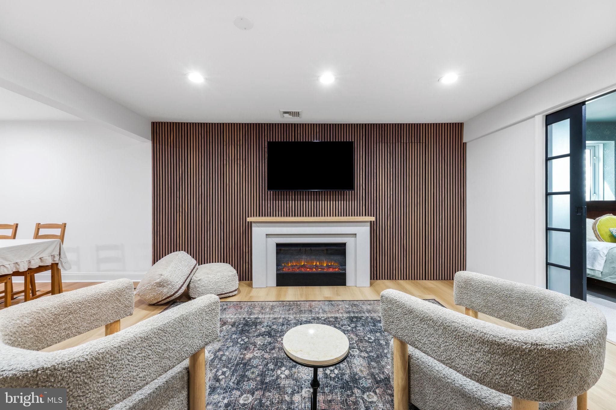 6513 Apple Blossom Ride Columbia, MD 21044 - Photo 65 of 115 a living room with furniture a flat screen tv and a fireplace