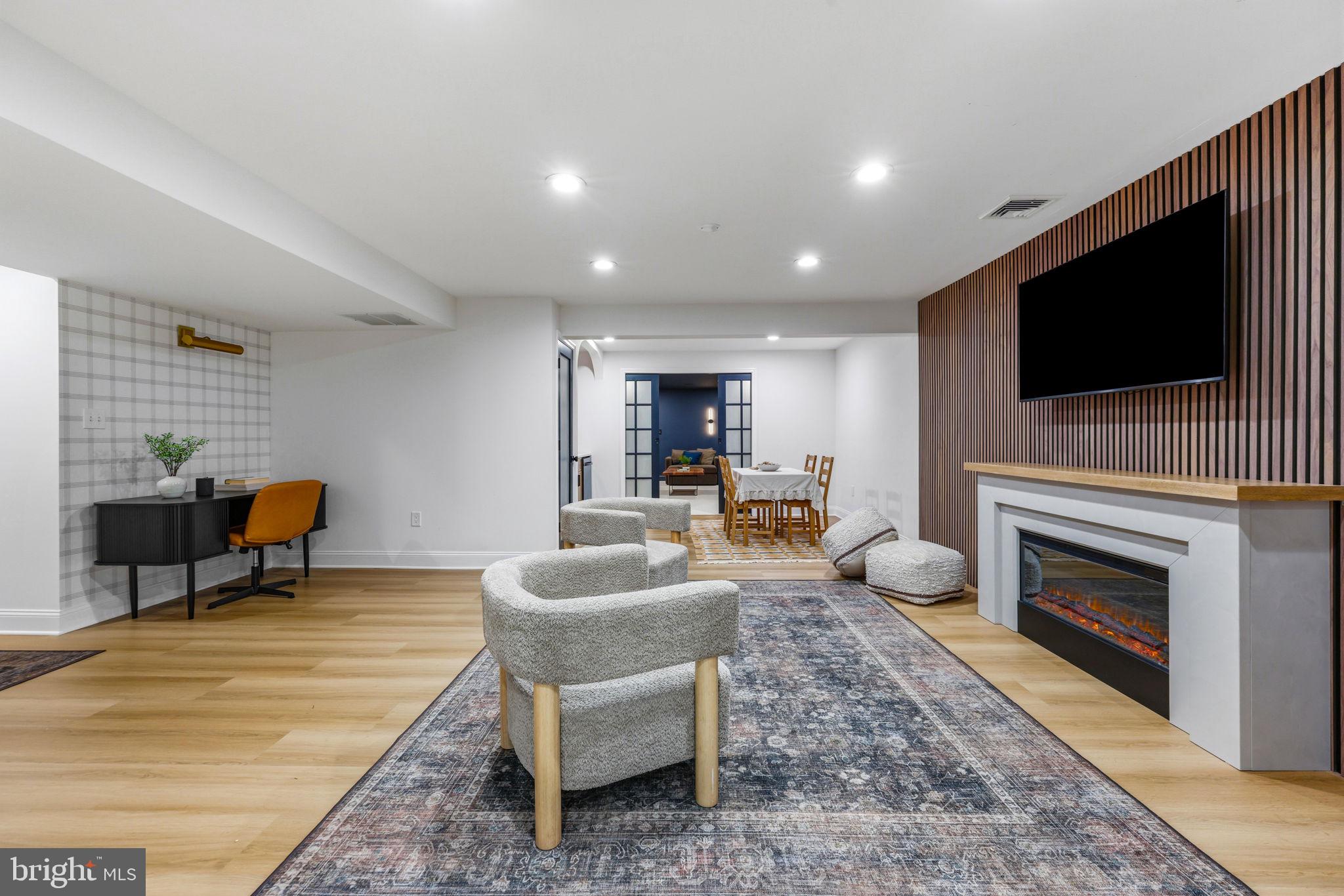 6513 Apple Blossom Ride Columbia, MD 21044 - Photo 70 of 115 a living room with furniture a flat screen tv and a fireplace
