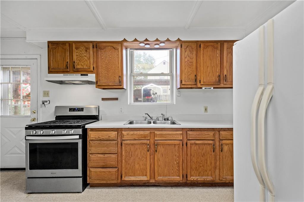 2927 Willett Road Pittsburgh, PA 15227 - Photo 11 of 24 a kitchen with stainless steel appliances a stove a sink and a microwave