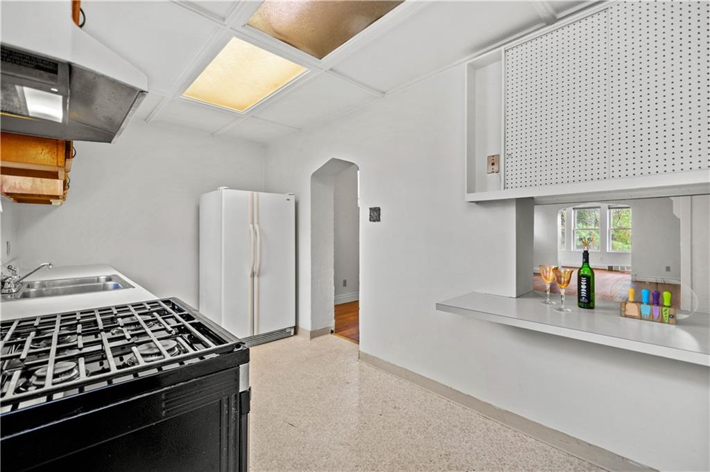 2927 Willett Road Pittsburgh, PA 15227 - Photo 12 of 24 a kitchen with appliances cabinets and a window