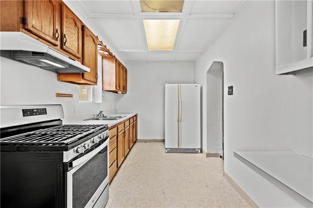 2927 Willett Road Pittsburgh, PA 15227 - Photo 13 of 24 a kitchen with stainless steel appliances granite countertop a stove and a refrigerator