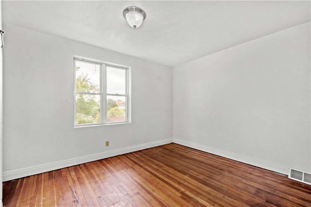 2927 Willett Road Pittsburgh, PA 15227 - Photo 15 of 24 an empty room with wooden floor and windows