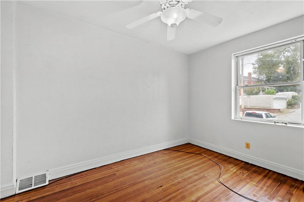2927 Willett Road Pittsburgh, PA 15227 - Photo 17 of 24 an empty room with wooden floor and windows