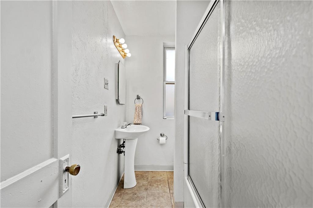 2927 Willett Road Pittsburgh, PA 15227 - Photo 19 of 24 a bathroom with a sink a mirror and shower