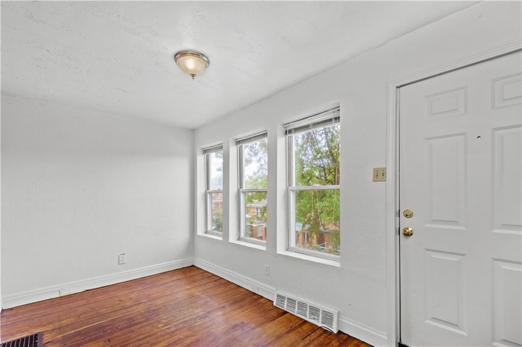 2927 Willett Road Pittsburgh, PA 15227 - Photo 3 of 24 a view of an empty room with wooden floor and a window