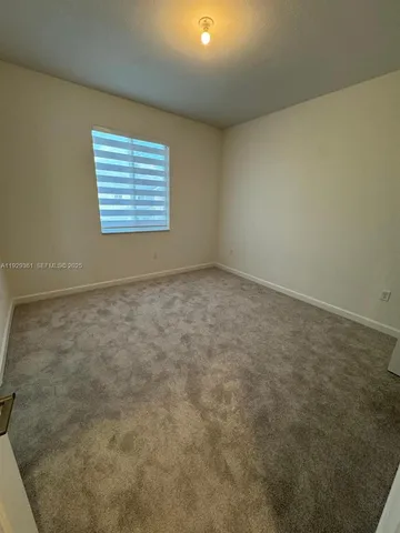 an empty room with closet and mirror