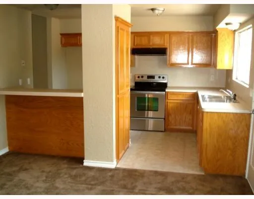 a kitchen with stainless steel appliances a refrigerator a stove and a sink