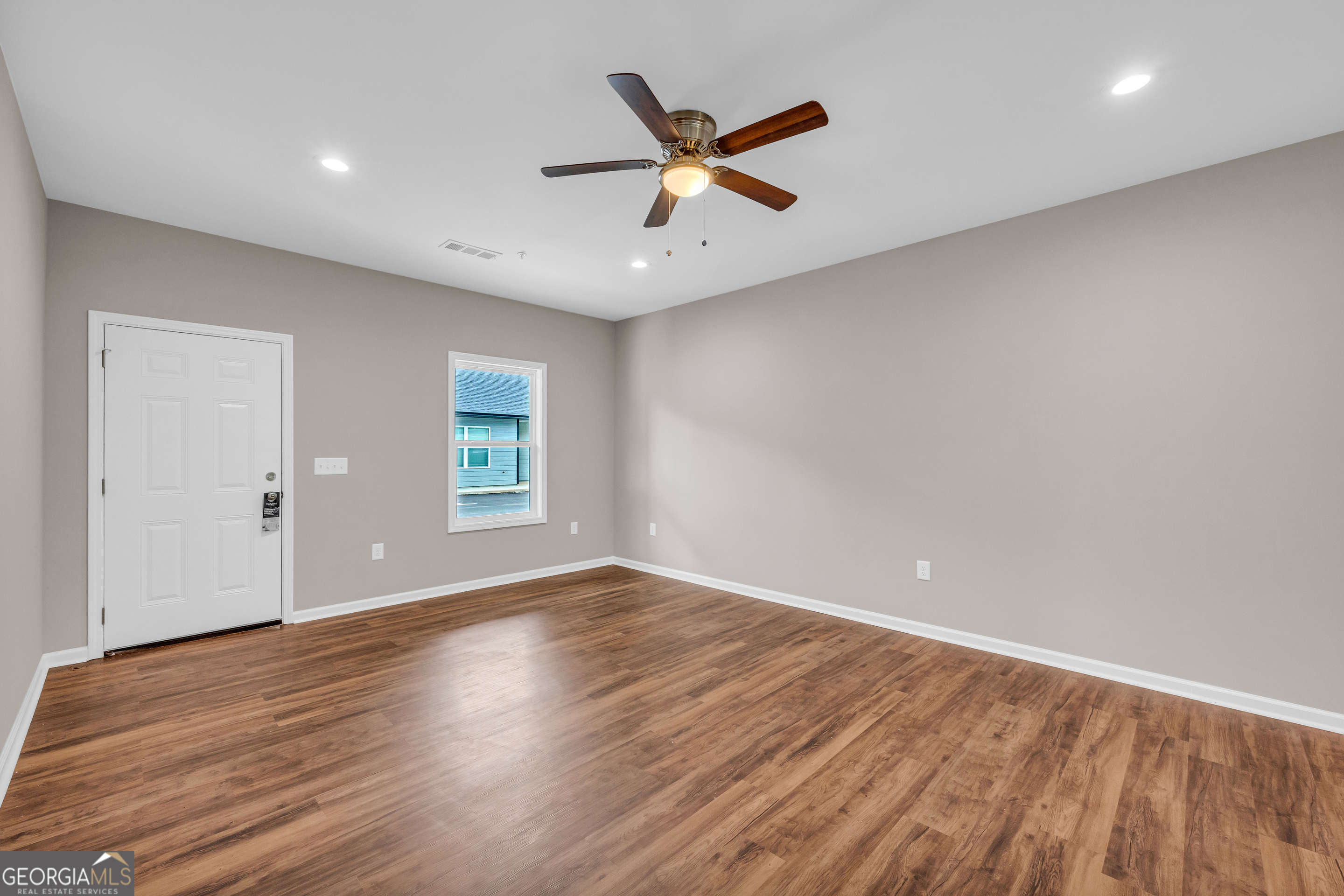339 A Gainesville Street Carnesville, GA 30521 - Photo 10 of 19 an empty room with wooden floor and windows