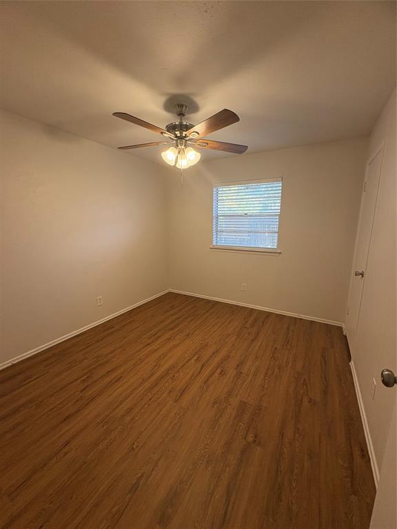 3717 Swallow Lane Irving, TX 75062 - Photo 11 of 11 Empty room with dark wood-style flooring and baseboards