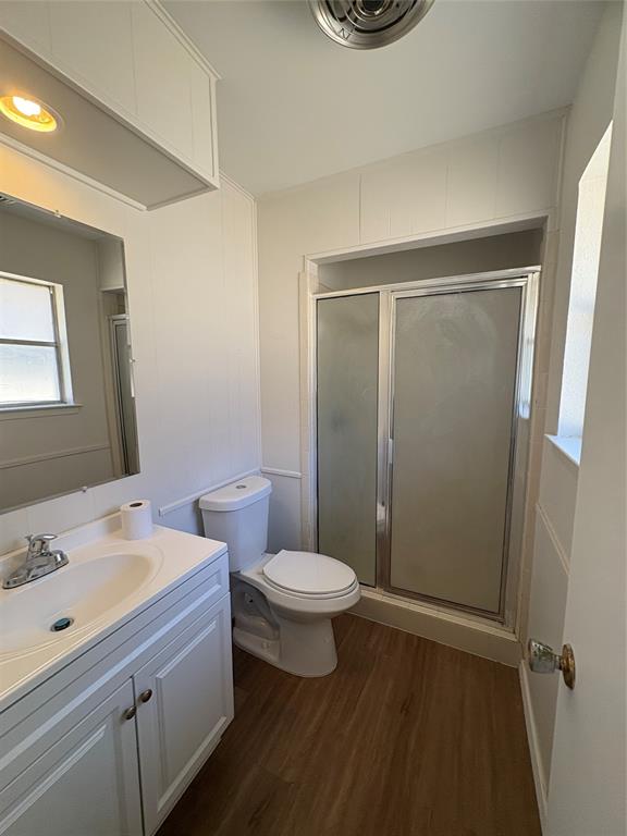 3717 Swallow Lane Irving, TX 75062 - Photo 8 of 11 Bathroom featuring dark wood-style floors, vanity, and a shower stall