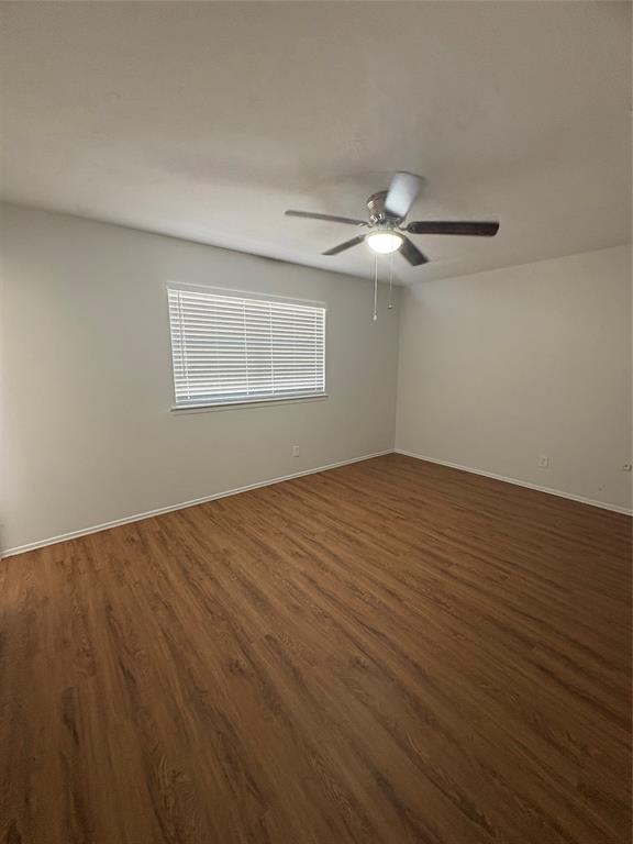 3717 Swallow Lane Irving, TX 75062 - Photo 10 of 11 Spare room featuring dark wood-type flooring and ceiling fan