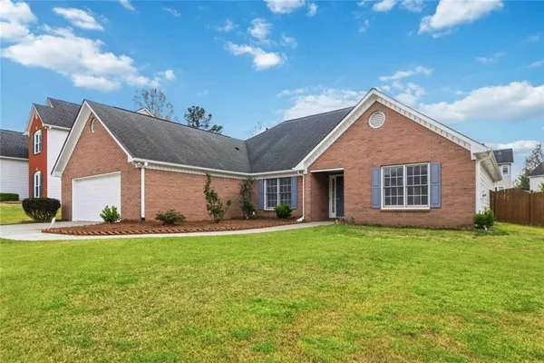 a front view of a house with a yard