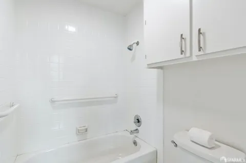 a bathroom with a bathtub and a toilet
