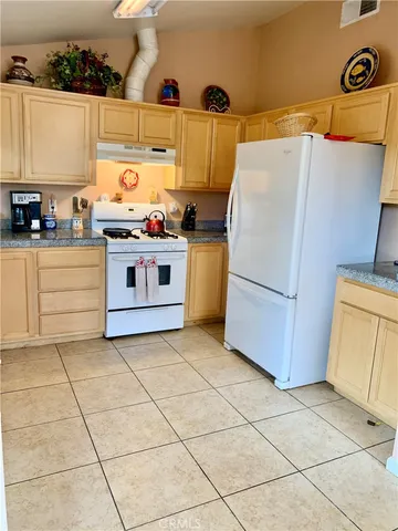 a kitchen with a stove top oven and cabinets