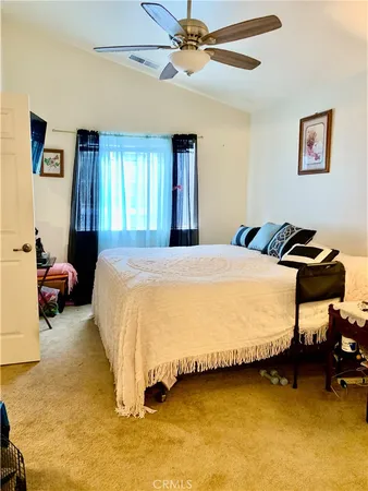 a bedroom with a bed and ceiling fan