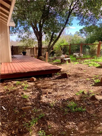 a view of backyard with large trees