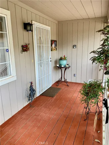 a bedroom with a bed and a potted plant