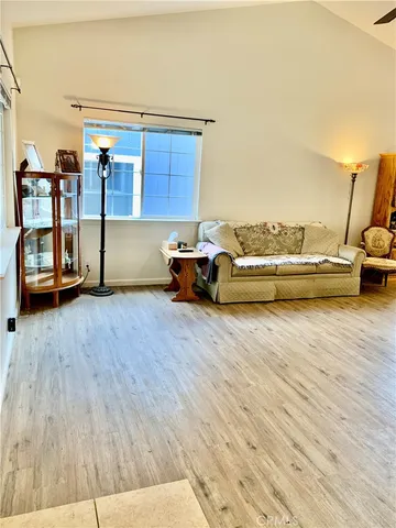 a living room with wooden floor and furniture