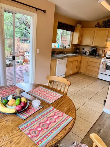 a bed sitting in a kitchen next to a window