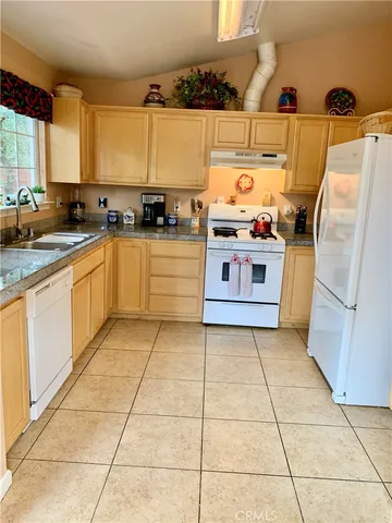 a kitchen with stainless steel appliances a stove a sink and a microwave
