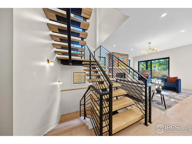 a living room with furniture a flat screen tv and a floor to ceiling window