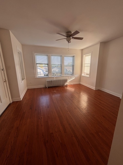 5521 West Farragut Avenue, Unit 3E Chicago, IL 60630 - Photo 4 of 12 a view of an empty room with wooden floor and a window