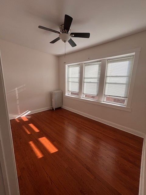 5521 West Farragut Avenue, Unit 3E Chicago, IL 60630 - Photo 6 of 12 a view of empty room with wooden floor and fan