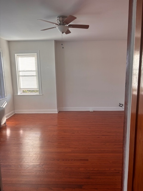 5521 West Farragut Avenue, Unit 3E Chicago, IL 60630 - Photo 10 of 12 a view of an empty room with wooden floor and a window