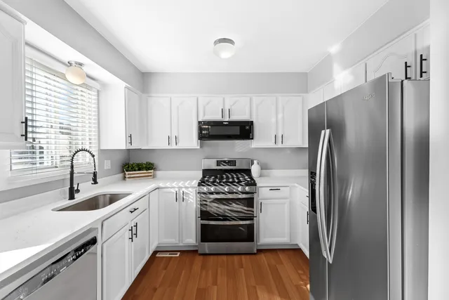 a kitchen with a sink stove and refrigerator