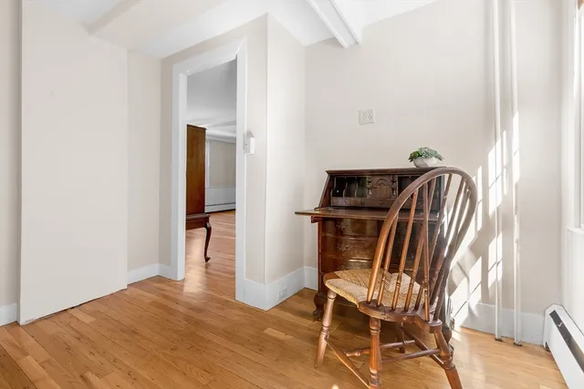 a view of a livingroom with furniture and a table chairs