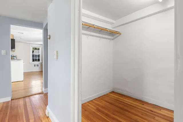 a bathroom with a sink a mirror and next to a window