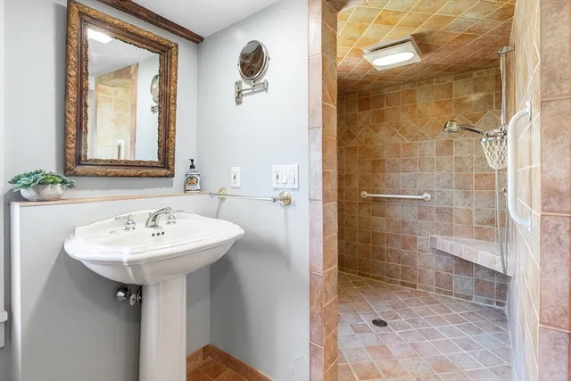 a bathroom with a sink toilet and a mirror