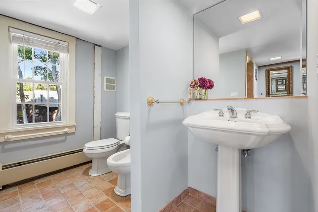 a view of a hallway with wooden floor and closet
