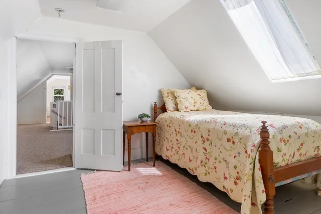 a bath room with a toilet a sink and a mirror