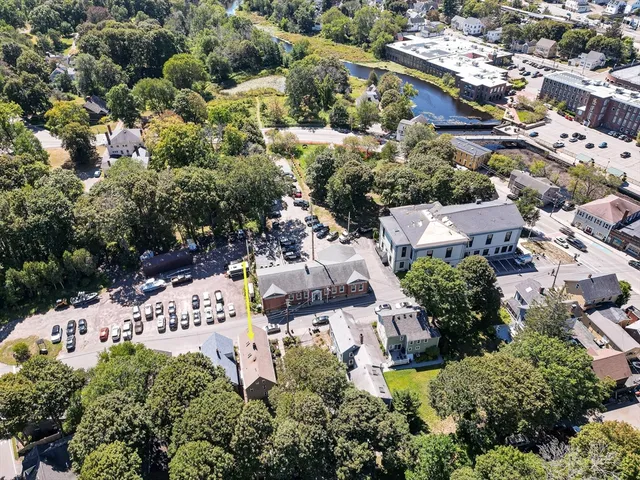 an aerial view of a house with a garden and lake view