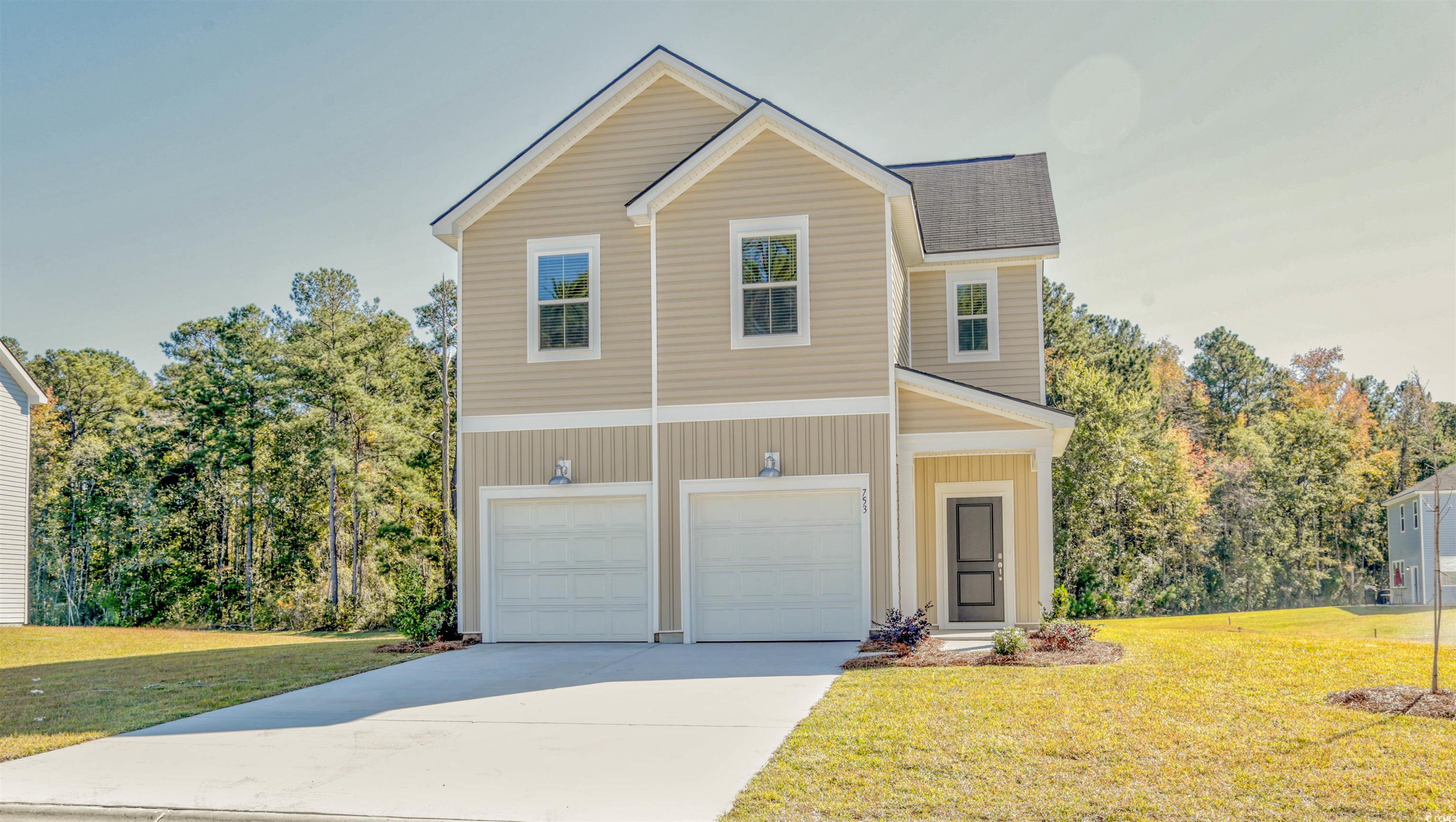 736 Sturdy Root Place Myrtle Beach, SC 29588 - Photo 1 of 15 View of front of house with a front lawn, concrete driveway, and a garage