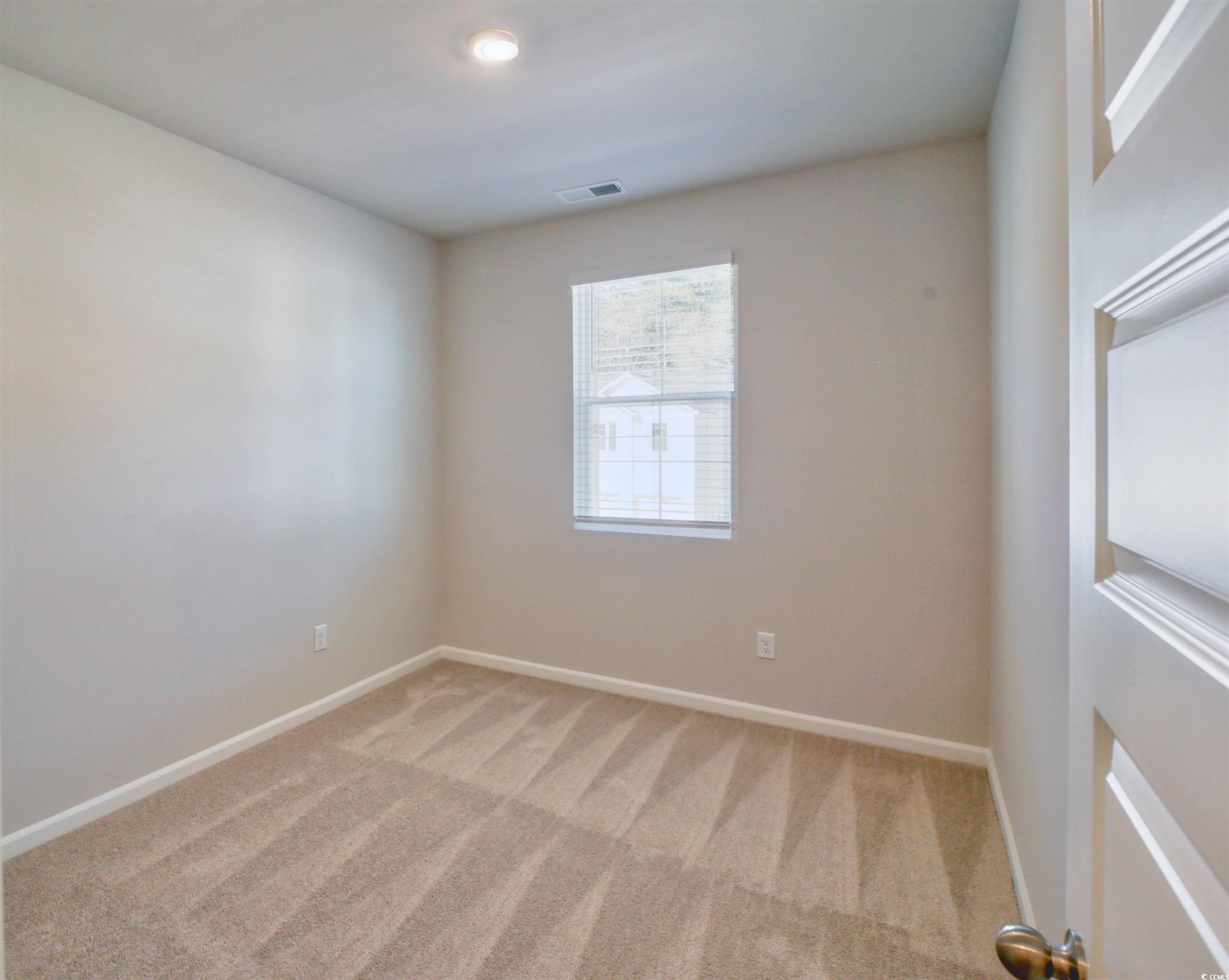 736 Sturdy Root Place Myrtle Beach, SC 29588 - Photo 5 of 15 Spare room with light carpet and baseboards