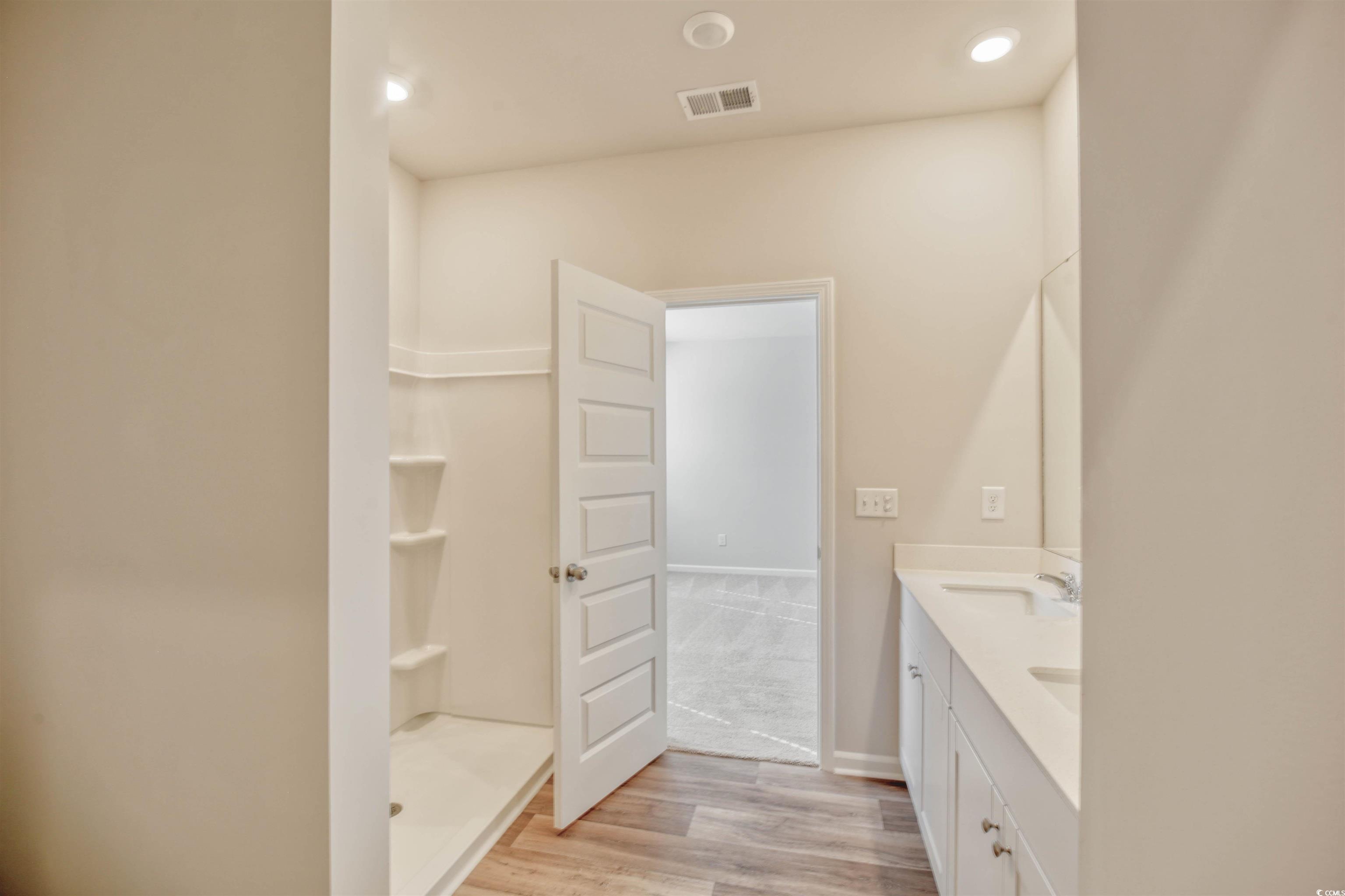 736 Sturdy Root Place Myrtle Beach, SC 29588 - Photo 9 of 15 Bathroom with double vanity, light wood-type flooring, a shower stall, and recessed lighting