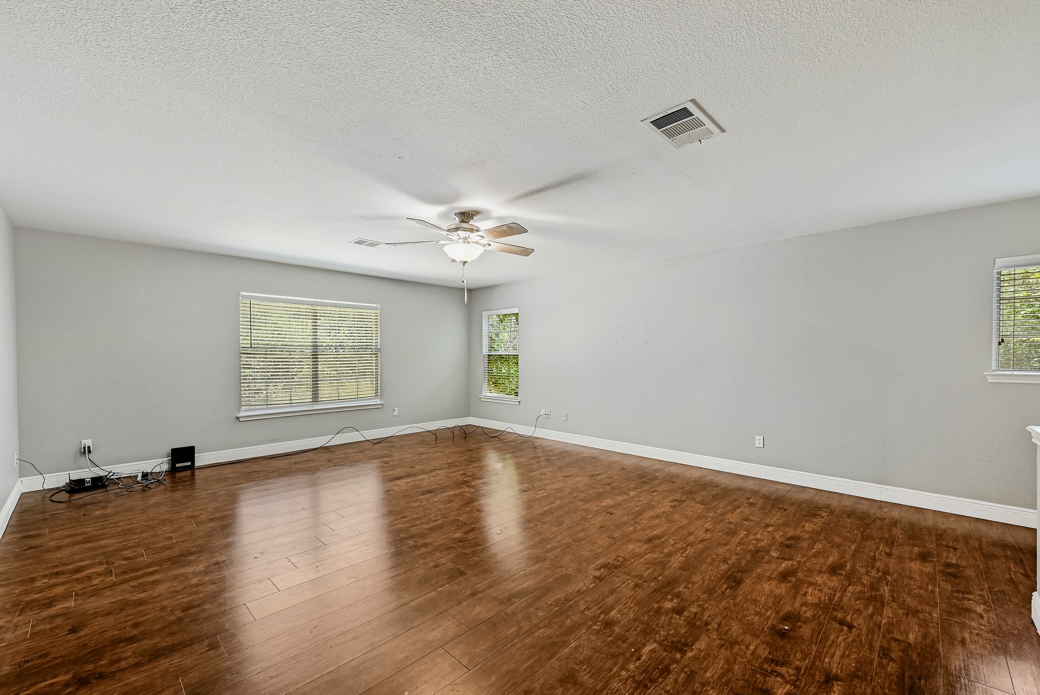 104 North Sumac Lane Georgetown, TX 78633 - Photo 26 of 40 Hardwood floors and generous natural light create an inviting atmosphere in this open living space.
