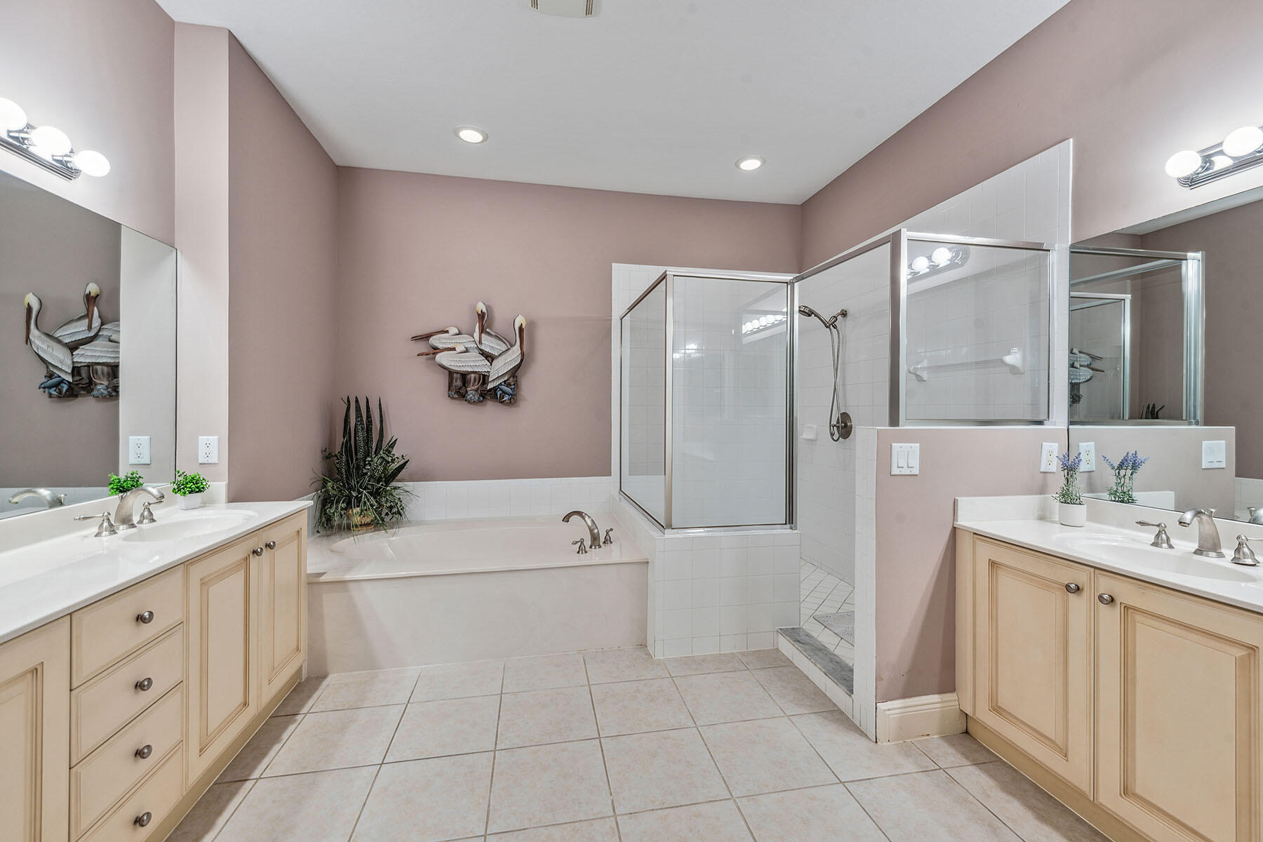 3189 Aviamar Circle, Unit 202 Naples, FL 34114 - Photo 15 of 50 a spacious bathroom with a double vanity sink a mirror a shower and a bathtub