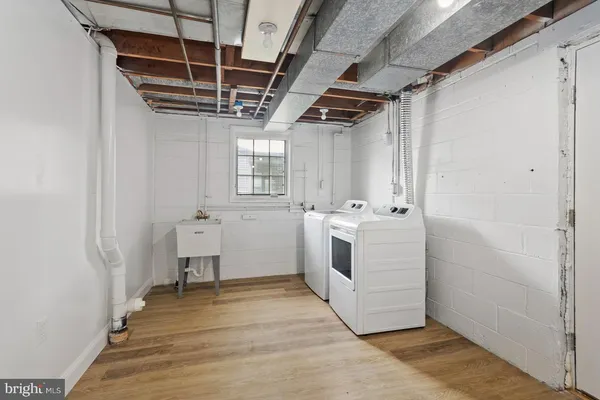 a utility room with cabinets washer and dryer