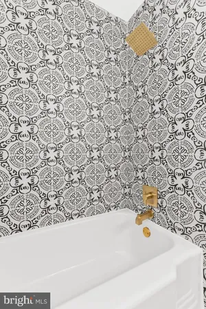 a bathroom with a bathtub and a sink