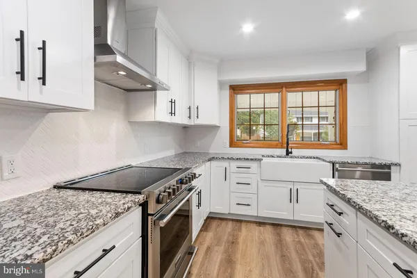 a kitchen with a sink stove and cabinets