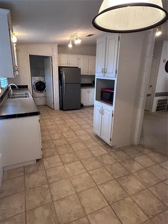 a view of a refrigerator and a sink