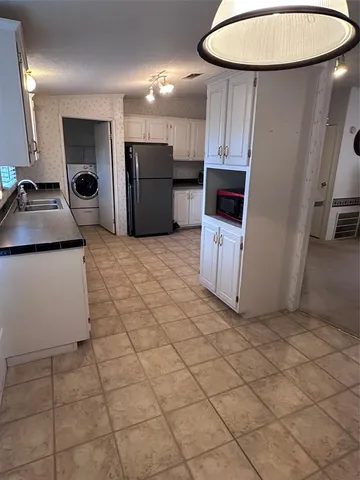 a view of a refrigerator and a sink