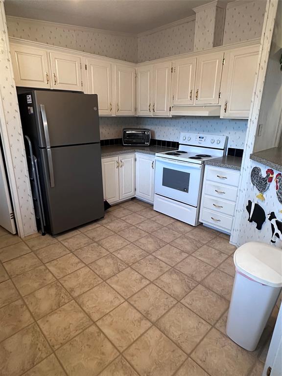 307 West Division Street Graford, TX 76449 - Photo 17 of 22 a kitchen with a refrigerator sink and cabinets