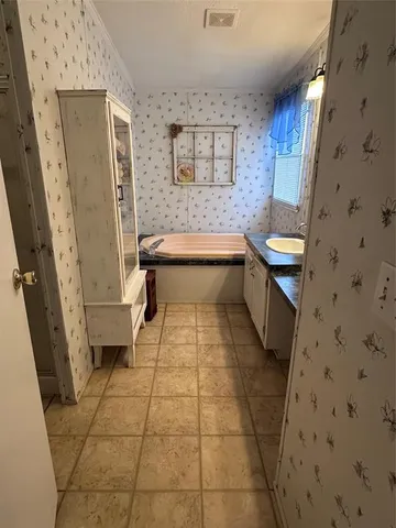 a bathroom with a sink a toilet and a shower