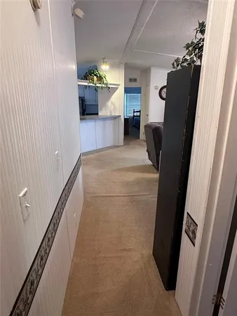 a view of kitchen with furniture and a refrigerator
