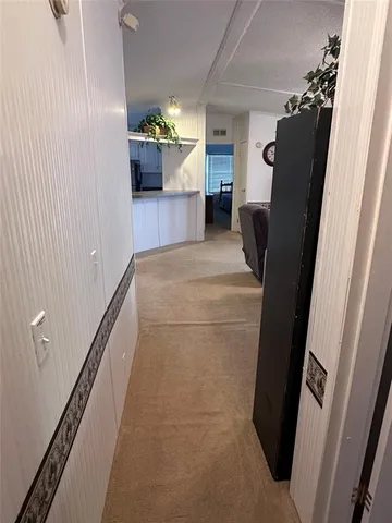 a view of kitchen with furniture and a refrigerator